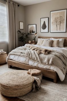 a large bed sitting in a bedroom next to two pictures on the wall above it