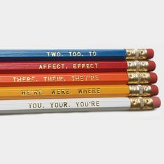 four pencils with words written on them