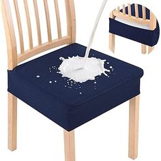 a wooden chair with a blue cushion and some white stuff on the seat, as well as a bottle of milk being poured into it