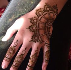 someone has henna tattooed on their hand