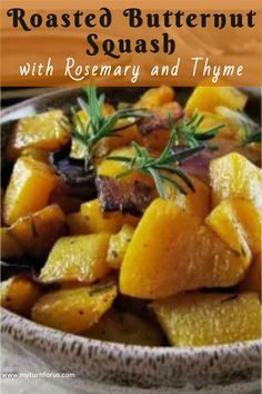 roasted butternut squash with rosemary and thyme in a bowl on a wooden table