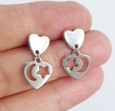 Stainless steel heart charm and stud drop earrings. Stainless steel earrings. Earring length: 21mm (from end to end) Charm size: 8mm Charm material: stainless steel Earring stud material: stainless steel Backs: rubber This listing is for one pair of heart charm earrings.  These earrings will come in a gift bag. I offer combined shipping costs which give you a shipping discount for ordering multiple items from my shop. Please note: this item will be sent via standard unregistered post, without tr Stainless Steel Earrings Studs, Stud Drop Earrings, Earrings Outfit, Heart Moon, Dangle Earrings Silver, Clear Nail Polish, Heart Dangle Earrings, Earring Stud, Steel Earrings