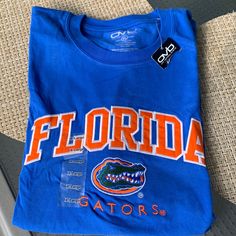 Never Worn Nwt Florida Gators Embroidered Tshirt, 100% Cotton Blue College T-shirt With Embroidered Logo, College Fan Apparel T-shirt With Embroidered Graphics, Cotton Tops With Embroidered Logo For Fan Gear, Cotton Tops With Embroidered Graphics For Fan Gear, Collegiate Blue Top With Embroidered Logo, Casual Tops With Embroidered Logo For Fan Gear, Casual Embroidered Graphics T-shirt For Fans, Casual T-shirt With Embroidered Graphics For Fans, Blue Embroidered College T-shirt