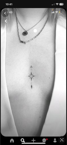 black and white photo of woman with cross tattoo on chest