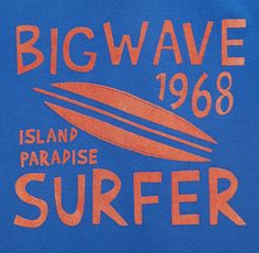 a blue shirt with an orange surfboard on the front that says big wave 1908 island paradise surfer