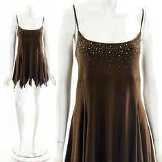 "- vintage 00's y2k brown stretchy tank jagged handkerchief hemline strappy dress - rhinestone detail on bodice - very stretchy and flowy Label: MKM Designs Tag Size: XL Fits like: Medium-Large Material: Polyester, Spandex Condition: Excellent Clipped on Mannequin: No ✂ SIZE + FIT ✂ Length: 32\" / 81 cm Sleeve Length: 11\" / 28 cm Bust: 30\" to 40\" / 76 cm to 102 cm Waist: 32\" to 46\" / 81 cm to 117 cm Hips: 60\" / 152 cm All measurements are taken with garment lying flat. ALWAYS refer to meas Dress Form Mannequin, Handkerchief Dress, Y2k Dress, Strappy Dress, Club Dress, Rhinestone Dress, Strappy Dresses, Dress Form, Club Dresses