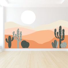 an empty room with a wall decorated with cactus and mountains in the background, along with wooden floors