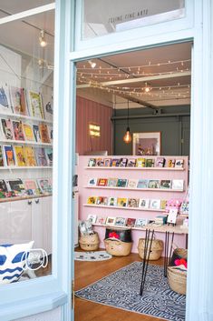 the inside of a book store with pink walls