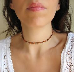 Beaded Choker Necklace Brown Choker Simple and elegant mixed copper, brown, gold and orange beaded choker with glass tiny seed beads. Perfect for wearing with other chokers or alone! DESCRIPTION Made from 2mm glass seed beads and closes with a gold plated clasp and 2 inches adjustable chain. SIZE Necklace is 13 inches and can be adjusted up to 15 inches with a 2 inches extender chain. Please let me know if you would like a different length. WRAPPING - All ZafireniaDainty jewelry arrive gift wrap Beaded Brown Choker As Gift, Brown Beaded Choker As Gift, Brown Faceted Beads Jewelry For Festival, Summer Brown Round Beads Jewelry, Brown Choker, Choker Simple, Gold And Orange, Colorful Necklace, Copper Brown