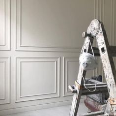 an old ladder is being used to paint the walls