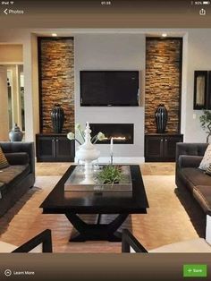 a living room filled with furniture and a flat screen tv mounted on the wall above a fireplace