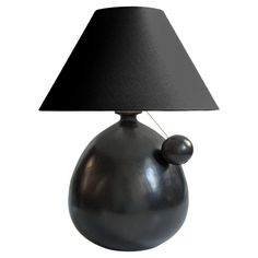 a black lamp on a white background with a black shade over the top and bottom