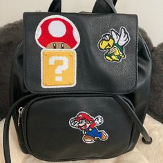 Time For Him To Get That Mushroom And Grow To The Size Of A Squishmonster! Bad Guys Beware. I Custom Made This Mini Backpack. It's A Magnetic Snap Closure With Pullies And A Front Pocket. Super Mario Bros, Gamers, Video Games, Cartoons, Movies, What Hasn't Mario Done? Black Bags With Logo Patch For Daily Use, Black Everyday Bags With Logo Patch, Everyday Black Bags With Logo Patch, Black School Backpack With Logo Patch, Casual Black Bags With Logo Patch, Black Backpack With Logo Patch, Black Standard Backpack With Logo Patch, Black Rectangular Bag With Logo Patch, Black Streetwear Bag With Logo Patch