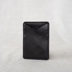 This Money Clip Wallet is perfect for the guy who loves to carry cash and a few cards. It's modern and sleek, and designed to hold the basics. Made with durable, full-grain leather, he'll love this purchase for years to come. Everyday Black Trifold Wallet With Smooth Grain, Leather Card Holder With Coin Pocket For Everyday Use, Minimalist Leather Card Holder With Rfid Blocking, Black Wallet With Flat Pocket, Everyday Leather Trifold Wallet With Flat Pocket, Leather Card Holder With Flat Pocket For Everyday Use, Minimalist Leather Wallet For Everyday Carry, Casual Everyday Trifold Wallet, Leather Wallet With Flat Pocket