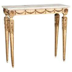 an antique console table with two legs and a marble top, in gold leaf design