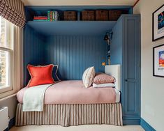 a bedroom with blue painted walls and pink bedding