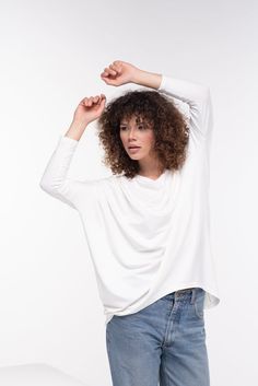 Comfortable soft cotton viscose tunic with 3/4 sleeve and a loose design. Boat neckline and casual goth vibe - this tunic is perfect for your everyday style.The model in the picture is 176cm. ⅼ 5.8 ft. tall and is wearing size S / color: Off white🌟 INFO:• Worldwide EXPRESS shipping – please provide a phone number for shipping documents• US Sizing XS to 4XL – body size chart available below• We offer customization to Personal Measurements & Larger Sizes 5XL, 6XL, 7XL ….🌟 MATERIAL & CARE Modern Summer Tops With 3/4 Sleeve, Modern 3/4 Sleeve Tops For Fall, Spring Lagenlook Blouse With Batwing Sleeves, White Lagenlook Tops With Asymmetrical Hem, White Asymmetrical Hem Lagenlook Tops, Relaxed Fit Long Sleeve Tunic For Layering, Asymmetrical Viscose Top For Spring, White 3/4 Sleeve Tops For Layering, Versatile Slouchy Long Sleeve Tops