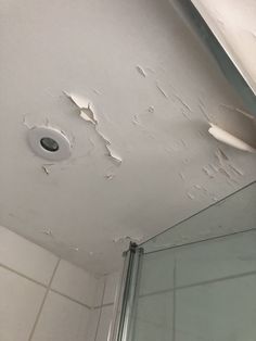 the ceiling in this bathroom has been torn off and is being replaced with white paint