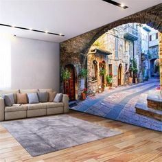 a living room with a large mural on the wall and wooden flooring in front of it