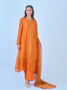 Elegant embroidered cotton net shirt with pants and dupatta a perfect choice for those who appreciate intricate detailing and graceful style. Crafted from high-quality cotton net fabric, this shirt offers a lightweight and luxurious feel, allowing you to feel comfortable and chic throughout the day. The set comes with a matching dupatta and pant which enhances the overall look and adds a touch of finesse to your outfit. Length: 47" Pants Fabric : Raw Silk Dupatta Fabric : Chiffon Festive Long Sleeve Sharara With Naqshi, Designer Naqshi Sharara For Navratri, Festive Straight Kurta Sharara With Naqshi, Festive Anarkali Set With Naqshi For Eid, Eid Jamawar Sharara With Naqshi Detailing, Festive Chanderi Lawn Suit With Dabka Work, Festive Chanderi Lawn Suit With Naqshi Detailing, Festival Lawn Suit In Jamawar With Naqshi Embroidery, Festive Lawn Suit With Naqshi In Cambric