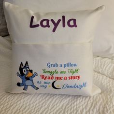 a pillow that says layla with an image of a cartoon character on the front