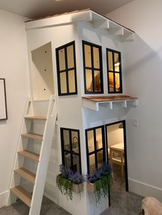 a model house with stairs and windows on the side