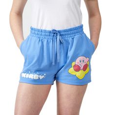 Elevate your casual wardrobe with these blue Kirby sweat shorts. Featuring a glitter puff print of Kirby on a warp star and his name in white letters, these shorts add a playful touch to your style. Crafted from a blend of 60% cotton and 40% poly French terry, they offer comfort and durability. The drawstring adjustable elastic waistband ensures a personalized fit. Officially licensed, these shorts showcase the authentic charm of Kirby. For easy care, machine wash these shorts on cold, tumble dr Trendy Cotton Athletic Shorts For Streetwear, Leisure Shorts With Letter Print, Leisure Letter Print Shorts, Trendy Letter Print Leisure Shorts, Blue Cotton Shorts With Letter Print, Blue Bottoms With Letter Print, Short Length, Blue Letter Print Shorts, Cotton Shorts With Letter Print, Trendy Shorts With Letter Print For Loungewear