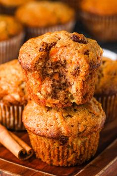 carrot muffins stacked on top of each other with cinnamon sticks in the background