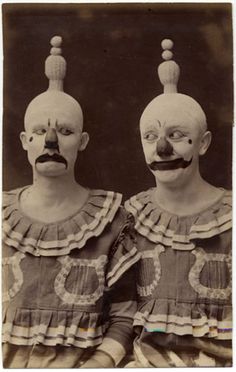 two creepy clowns are posing for a photo