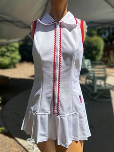 Here is a vintage 1970s Fashion T brand polyester tennis dress .No size.Following are the measurements.Bust 34",Waist 30",Hips 38",Length measured from top of shoulder to hem 29"long.Zips up the front.Made out of white polyester fabric.Zig zag red trim.Nice vintage condition.Please take special consideration of measurements. 1970s sizing was much smaller than today's standards.Tennis dresses were very short not like a regular dress. So please take special note of length.If you live overseas plea Fitted White Tennis Dress With Short Sleeves, Fitted Cotton Tennis Dress, Fitted Cotton Tennis Dress For Spring, Tennis Dresses, 60s And 70s Fashion, Seventies Fashion, Trim Fabric, 2024 Style, 1970s Dresses