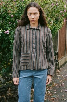 A slightly cropped striped wool jacket with button front and single patch pocket.    cawley    -    brown/charcoal stripe    -    100% japanese boucle wool  -    fit is true to size  -    mauria is 5’10" size 8 uk and is wearing a size s  -    made in uk    worn with  caro editions trousers and cawley sheepskin hat Caro Editions, Sheepskin Hat, Layering Jacket, Brown Oxfords, Mohair Wool, Linen Skirt, Engineered Garments, Wool Jacket, Black Cardigan