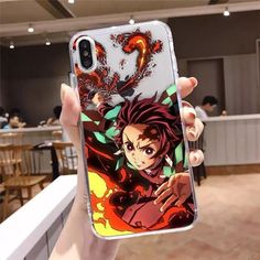 a person holding up a phone case with an anime character on it