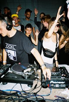 a group of people at a party with djs