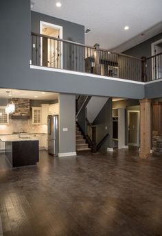 a large open floor plan with stairs leading up to the second story