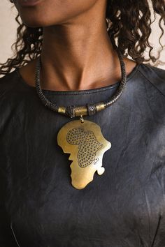 Handcrafted Necklaces - Handmade - African Art - Jewelry - Beaded Necklaces - This beautiful Africa Map pendant necklace is finely crafted from premium leather and bronze. It's perfect for any occasion and adds a unique tribal touch to your wardrobe. The intricate detailing and timeless design will last for years to come! Length: 12 Inventory # 10829 African Drawings, African Inspired Jewelry, Map Pendant, Africa Map, African Diaspora, Bronze Pendant, Inspired Jewelry, African Inspired, Leather Jewelry