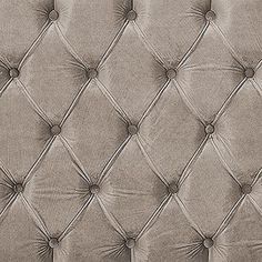 an upholstered leather headboard with buttons on the top and bottom, in grey