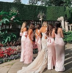 the bridesmaids are all dressed in pink gowns