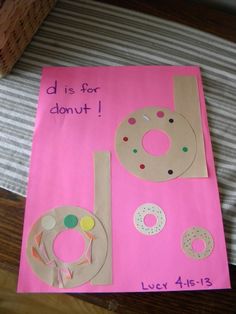 a paper bag with doughnuts and donuts on it sitting on a bed