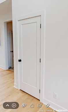 an empty room with two doors and a flat screen tv mounted on the wall above it