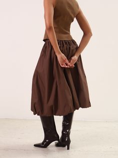 The Brown Bella Midi Bubble Skirt is perfect for those who love a playful twist on their wardrobe. With its elasticated waist, comfort is guaranteed while the bubble hem adds volume and movement to your look. To elevate this skirt, simply pair it with a fitted tee and some cute flats. PRODUCT DETAILS + CARE: - Hand wash - Fabric: Self: 100% Cotton - Lining: 100% Cotton Midi Bubble Skirt Outfit, Long Bubble Skirt, Black Herringbone, Vintage Lifestyle, Cute Flats, Bubble Hem, Bubble Skirt, Denim Hat, Astr The Label