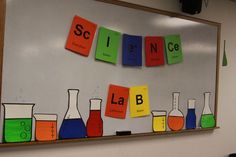 science themed bulletin board with colorful flasks on it