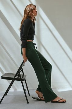 Easy and effortless lounge pants by Out From Under. Cut in a low-rise with a flared silhouette at the legs. Topped with an adjustable drawstring waistband. Only at UO. Features Out From Under Easy Does It flare pant Low rise lounge pant Soft and stretchy knit Low rise waistline with drawstring tie Fitted through waist, hips and thighs Slim bootcut fit Full length Pull-on construction UO exclusive Content + Care 100% Cotton Machine wash Imported Size + Fit Model in Navy is 5’10.5" and wearing size Small Measurements taken from size Small Waist: 24" Inseam: 33" | Out From Under Easy Does It Flare Pant in Green, Women's at Urban Outfitters Easy Does It, Flare Pant, Green Fits, Green Pants, Cute Everyday Outfits, Peter Parker, Small Waist, Lounge Pants, Muted Colors