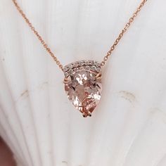 This beautiful pendant necklace features a 2.78 carat pear shape Morganite gemstone with natural earth mined diamonds set in solid 14K gold. This necklace can be a lovely June birthstone gift for your loved ones! This necklace is made with solid 14k gold and natural earth-mined SI G/H diamonds. As listed, this necklace is ready to ship. If you're interested in purchasing this setting with a different center stone please message us! Pear-shaped Morganite Jewelry, Pear Shaped Rose Gold Fine Jewelry Necklace, Pear-shaped Rose Gold Fine Jewelry Necklace, Pear Shaped Rose Gold Fine Necklace, Rose Gold Pear-shaped Gemstone Necklaces, Rose Gold Pear-shaped Gemstone Necklace, Morganite Necklace, Morganite Pendant, Designer Silver Jewellery