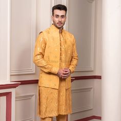 Elevate your festive wardrobe with this stunning mustard yellow kurta and waistcoat set. Crafted from a lightweight fabric, this ensemble is designed for comfort and style, making it perfect for celebrations and special occasions. The kurta features exquisite floral and leaf embroidery, showcasing a blend of traditional artistry and contemporary design. Paired with a matching waistcoat, this outfit not only complements the kurta but also enhances your overall look with its sophisticated charm. K Yellow Koti Kurta For Men, Yellow Kurta Design For Men, Haldi Kurta For Men Yellow, Prince Coat Shalwar Kameez, White And Yellow Kurta For Men, Mustard Kurta Men, Yellow Waistcoat, Black Tuxedo Suit, Waistcoat Designs