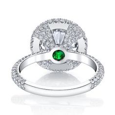 a white gold ring with green and white diamonds