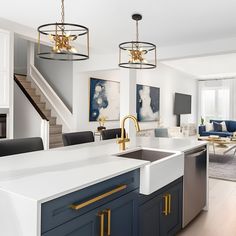 a kitchen and living room are shown in this modern style home with white countertops