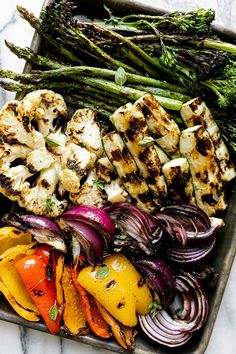 grilled vegetables on a tray with asparagus and broccoli