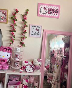 a hello kitty themed room with pink accessories and decor on the walls, including teddy bears