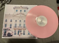 a pink vinyl record sitting on top of a couch