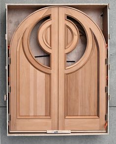 an open wooden door with the letters p and p in it's center section